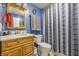 Cozy bathroom featuring blue walls, patterned shower curtain, vanity with sink, and decorative touches, perfect for relaxation at 5824 Wesley Rdg, Martinsville, IN 46151