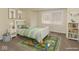 Bright bedroom with a colorful rug, toy cars, and a playful aesthetic at 5824 Wesley Rdg, Martinsville, IN 46151
