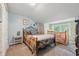 Comfortable bedroom featuring carpeted floors, a unique wrought iron bed frame, and a separate Bedroom area with a crib at 5824 Wesley Rdg, Martinsville, IN 46151