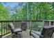 Wooden deck featuring outdoor seating with green cushions and leafy scenery at 5824 Wesley Rdg, Martinsville, IN 46151