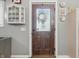 Inviting entryway featuring a decorative wooden door with sidelight and wall decor at 5824 Wesley Rdg, Martinsville, IN 46151