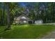Charming home nestled amongst lush trees, featuring an attached garage and a well-maintained lawn at 5824 Wesley Rdg, Martinsville, IN 46151