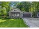 Charming home featuring brick accents, an attached garage, and a well-manicured lawn surrounded by lush trees at 5824 Wesley Rdg, Martinsville, IN 46151