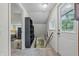 Hallway featuring carpeted steps, bright lighting, and doorway views to the bedroom area and a back door at 5824 Wesley Rdg, Martinsville, IN 46151