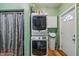Convenient laundry room featuring a stacked washer and dryer, ample storage space, and a door to the backyard at 5824 Wesley Rdg, Martinsville, IN 46151
