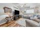 Inviting living room with a grey sofa, decorative lamps, and a large screen television at 5824 Wesley Rdg, Martinsville, IN 46151