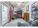 Eclectic living room featuring bright wallpaper, built-in shelving, comfortable seating, and unique decor for a cozy vibe at 5824 Wesley Rdg, Martinsville, IN 46151