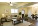 Comfortable living room with a ceiling fan, a beige couch, coffee table and an accent chair at 5824 Wesley Rdg, Martinsville, IN 46151