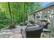 Outdoor patio with cozy seating arrangement, BBQ grill, and lush green backdrop at 5824 Wesley Rdg, Martinsville, IN 46151