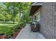 Charming brick home featuring a cozy, furnished front porch with lush landscaping at 5824 Wesley Rdg, Martinsville, IN 46151