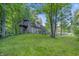 Rear view of home featuring an elevated deck nestled in a mature tree setting at 5824 Wesley Rdg, Martinsville, IN 46151