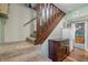 Carpeted stairway featuring wooden railing and trim and a lower cabinet at 5824 Wesley Rdg, Martinsville, IN 46151