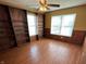 This bedroom features built-in bookshelves and ample natural light from the windows at 5850 Pennekamp Dr, Plainfield, IN 46168