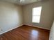 This is a simple bedroom with a ceiling fan and natural light from the window at 5850 Pennekamp Dr, Plainfield, IN 46168
