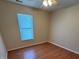 This is a simple bedroom with a ceiling fan and natural light from the window at 5850 Pennekamp Dr, Plainfield, IN 46168