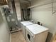 This laundry room features a washer, dryer, and overhead storage shelves for added convenience at 5850 Pennekamp Dr, Plainfield, IN 46168