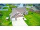 Aerial view showcases the well maintained yard, long driveway, and attached garage at 59 Manchester Dr, Trafalgar, IN 46181
