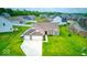 Aerial view features lush landscaping, long driveway, and an attached two-car garage at 59 Manchester Dr, Trafalgar, IN 46181