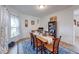 Cozy dining room with wooden table, six chairs, a blue rug, and natural light at 59 Manchester Dr, Trafalgar, IN 46181