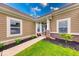 Inviting front entrance with decorative brick accents, manicured landscaping, and welcoming details at 59 Manchester Dr, Trafalgar, IN 46181