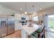 Bright kitchen with white cabinets, stainless steel appliances, and a cozy breakfast bar with seating at 59 Manchester Dr, Trafalgar, IN 46181