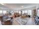 Open-concept living room with hardwood floors, a comfortable seating arrangement, and backyard views at 59 Manchester Dr, Trafalgar, IN 46181