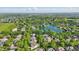 Expansive aerial view of the neighborhood featuring mature trees, well-manicured lawns, and a serene lake at 5940 Chapmans Trl, Carmel, IN 46033