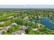 Aerial view of a residential community with lake, homes, and lush trees at 5940 Chapmans Trl, Carmel, IN 46033