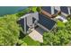 Aerial view of a home with a well-manicured lawn, a long driveway, and lush trees at 5940 Chapmans Trl, Carmel, IN 46033