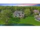 Aerial view of a two-story home featuring a large backyard, deck, and lush landscaping at 5940 Chapmans Trl, Carmel, IN 46033
