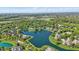 Aerial view of a lake community showing serene water, lush landscaping, and beautiful homes at 5940 Chapmans Trl, Carmel, IN 46033