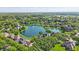 Aerial view of community with houses surrounding a beautiful lake at 5940 Chapmans Trl, Carmel, IN 46033
