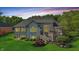 Back exterior view of home with large deck overlooking gorgeous landscaping and lush greenery at 5940 Chapmans Trl, Carmel, IN 46033