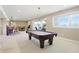 Finished basement with a pool table, wet bar, dining area, and workout area at 5940 Chapmans Trl, Carmel, IN 46033