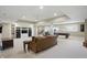Spacious finished basement featuring a lounge area, workout space, and pool table for recreation at 5940 Chapmans Trl, Carmel, IN 46033