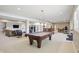 Spacious finished basement with a lounge area, pool table, wet bar, and workout area at 5940 Chapmans Trl, Carmel, IN 46033