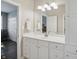 Well-lit bathroom with white cabinets, and large mirror at 5940 Chapmans Trl, Carmel, IN 46033