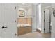 Bathroom featuring a bathtub with tile surround, a walk-in shower, and white doors at 5940 Chapmans Trl, Carmel, IN 46033