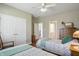 Bright bedroom with two twin beds, wooden furniture, and access to ensuite bathroom at 5940 Chapmans Trl, Carmel, IN 46033