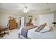 Neutral bedroom with a wrought iron bed, desk, and wood furniture at 5940 Chapmans Trl, Carmel, IN 46033