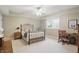 Neutral bedroom with a wrought iron bed, desk, and neutral carpet at 5940 Chapmans Trl, Carmel, IN 46033
