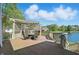 Outdoor deck with pergola and seating area overlooking lush lawn and lake at 5940 Chapmans Trl, Carmel, IN 46033
