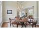 Elegant dining room featuring a chandelier, ample seating, and views into the living room at 5940 Chapmans Trl, Carmel, IN 46033