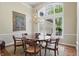Elegant dining room featuring a large window, chandelier, and ample seating for formal gatherings at 5940 Chapmans Trl, Carmel, IN 46033