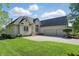 Elegant brick home with a manicured lawn, two-car garage, and beautiful landscaping at 5940 Chapmans Trl, Carmel, IN 46033