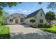 Stunning brick home with a well-manicured lawn, mature trees, and a spacious driveway for a welcoming curb appeal at 5940 Chapmans Trl, Carmel, IN 46033