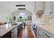 Gourmet kitchen with custom cabinets, a large island with marble countertops, and stainless steel appliances at 5940 Chapmans Trl, Carmel, IN 46033