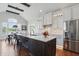 Gourmet kitchen with custom cabinets, a large island with marble countertops, and stainless steel appliances at 5940 Chapmans Trl, Carmel, IN 46033