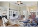 Inviting living room features a soaring ceiling, hardwood floors, and a cozy built in media center at 5940 Chapmans Trl, Carmel, IN 46033