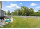 Expansive backyard with a basketball court, patio area, green lawn, and a white picket fence for privacy at 6107 Flagler Ln, Brownsburg, IN 46112